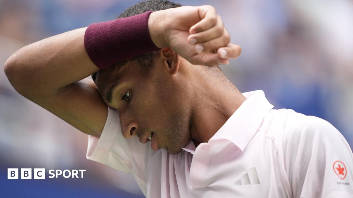 Felix Auger-Aliassime wipes his brow during his US Open defeat by Karen Khachanov