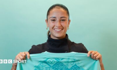 A smiling Jana Fernandez holds a London City shirt